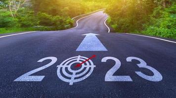 New year 2023 or straight forward concept. Text 2023 written on the road in the middle of asphalt road, Concept of planning, goal, challenge, new year resolution. photo