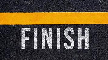 Finish text written and yellow line on the road in middle of the asphalt road, for business planning strategies and challenges, road to success concept, Finish word on street photo