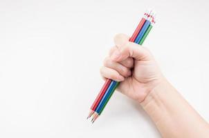 Colorful Pencil  in fist   power of written word on white background photo