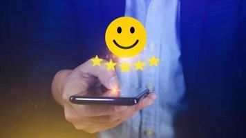 Customer services best excellent business rating experience, Positive Review and Feedback, Satisfaction survey concept. Hand of a businessman show happy smile face with five star. photo