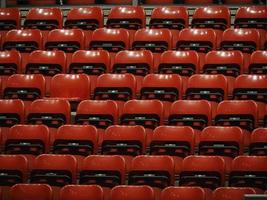 Bright red stadium seats on the stand photo