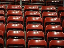 Bright red stadium seats on the stand photo