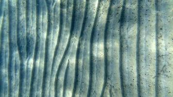 sand bottom underwater swimming in turquoise lagoon photo