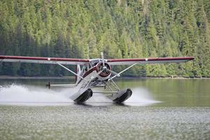 A Floatplane while landing on Alaskan lake photo