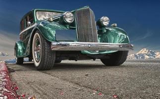 Old Green Chromated Car over deep blue sky photo