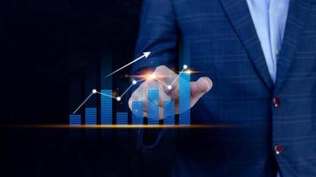 Businessman finger touch symbol stock graph and chart background, concept growth and development business investment, Stock market and strategy making market plan and stock market fluctuations photo