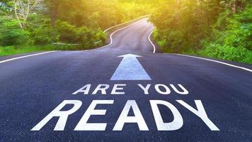Are you ready written on the middle of the asphalt curve road. Are you ready Write on the road in the middle of the empty asphalt road photo