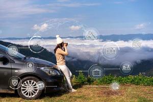 Young woman travelers with car watching a beautiful sea of fog over the mountain while travel driving road trip on vacation with travel icons diagram concept photo