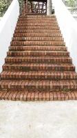 Outdoor bricks stair step and white wall. photo