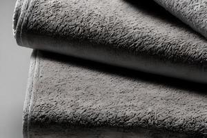 Close up clean gray folded towel stack each other. photo