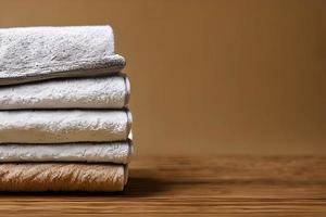Clean colorful folded towel nice and tidy stack each other and some negative space for fitness, bath, swimming, massage and spa marketing background and design material isolated on brown background. photo