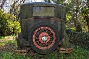 Old abandoned Rusted Car in a field photo