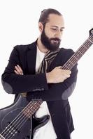 studio portrait of young bass player on white background photo