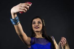 smiling beautiful indian girl takes a selfie photo