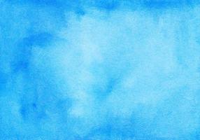 Watercolor calm blue background texture hand painted. Watercolour sky blue stains on paper. photo