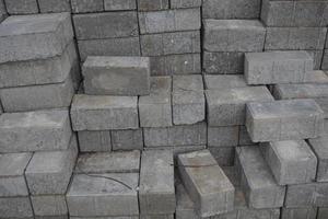 Stack of gray bricks for building construction photo