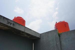 big orange water reservoir on the roof of the house. photo