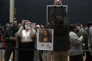 PARIS, FRANCE - NOVEMBER 18 2021 - Mona Lisa room is crowded of people photo