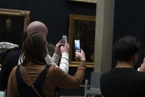 PARIS, FRANCE - NOVEMBER 18 2021 - Mona Lisa room is crowded of people photo