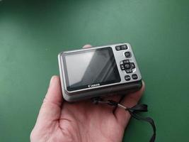 KYIV, UKRAINE - DECEMBER 18, 2023 Compact digital camera in hand photo