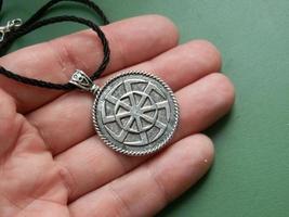 Religious metal symbol medallion in hand photo