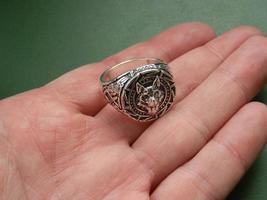 Religious metal symbol medallion in hand photo