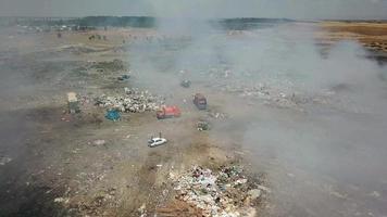 Drone flying over a smoking city dump. Huge dump. video