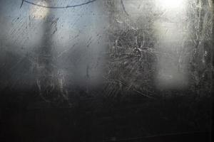 Scratched surface. Scratches on glass. Texture transparent in small strokes. photo