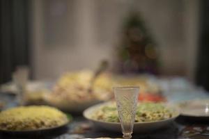 Glass of vodka on table. Festive table. Glass for alcoholic beverage. photo