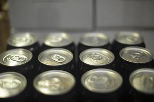 Cans with drink. Carbonated alcohol. Aluminum cans stand in row. photo