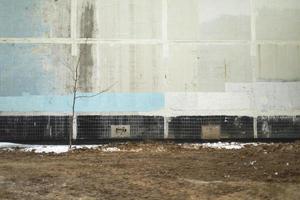 Wall of building without windows. House in detail. Old residential apartment building. photo