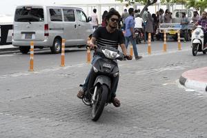 MALE, MALDIVES - FEBRUARY 16 2019 - Traffic in the street before evening pray time photo