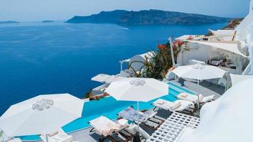 Vacation at Santorini swimming pool looking out over the Caldera ocean of Santorini,Oia Greece