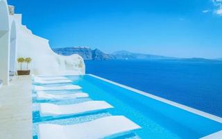 Vacation at Santorini swimming pool looking out over the Caldera ocean of Santorini,Oia Greece