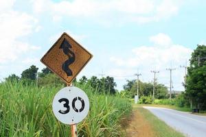 Traffic signs Be careful of roads and curves. Drive slowly and be careful of the curves ahead on rural highways and beautiful blue skies. photo