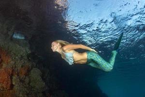 Blonde beautiful Mermaid diver underwater photo