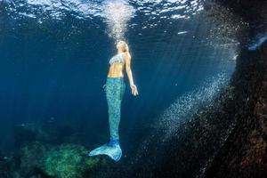 Blonde beautiful Mermaid diver underwater photo