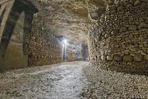 a ghost shape inside Paris Catacombs Skulls and bones photo