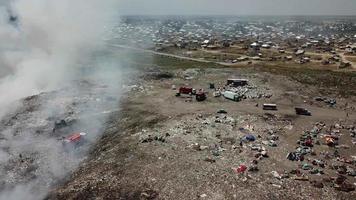 Drone flying over a smoking city dump. Huge dump. video