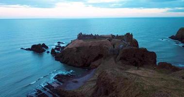 Aerial view of the ruins ancient Donator Castle in Scotland video