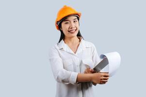 Young female engineer wearing Yellow helmet and clipboard photo