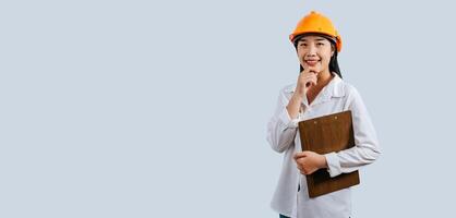 Young female engineer wearing Yellow helmet and clipboard photo