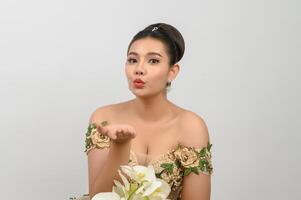 Young asian beautiful bride with orchid bouquet on white background photo