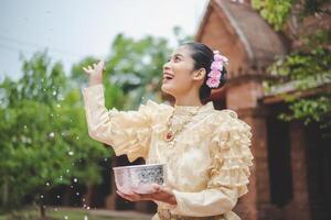 Portrait beautiful woman in Songkran festival with Thai Traditional costume photo