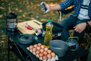 Portrait of Asian man glasses cooking at campsite photo