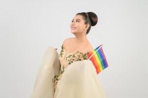 Young asian beautiful bride with rainbow flag on white background photo