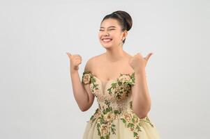 Young asian beautiful bride pose thumb up  on white background photo