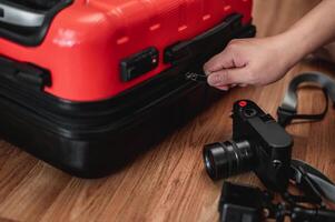 Close-up of man have finished packing and is locking them photo
