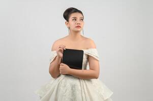 Young asian beautiful bride pose with tablet in hand photo