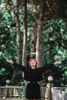Portrait of Happy Asian young woman in winter costume at the forest with copy space photo